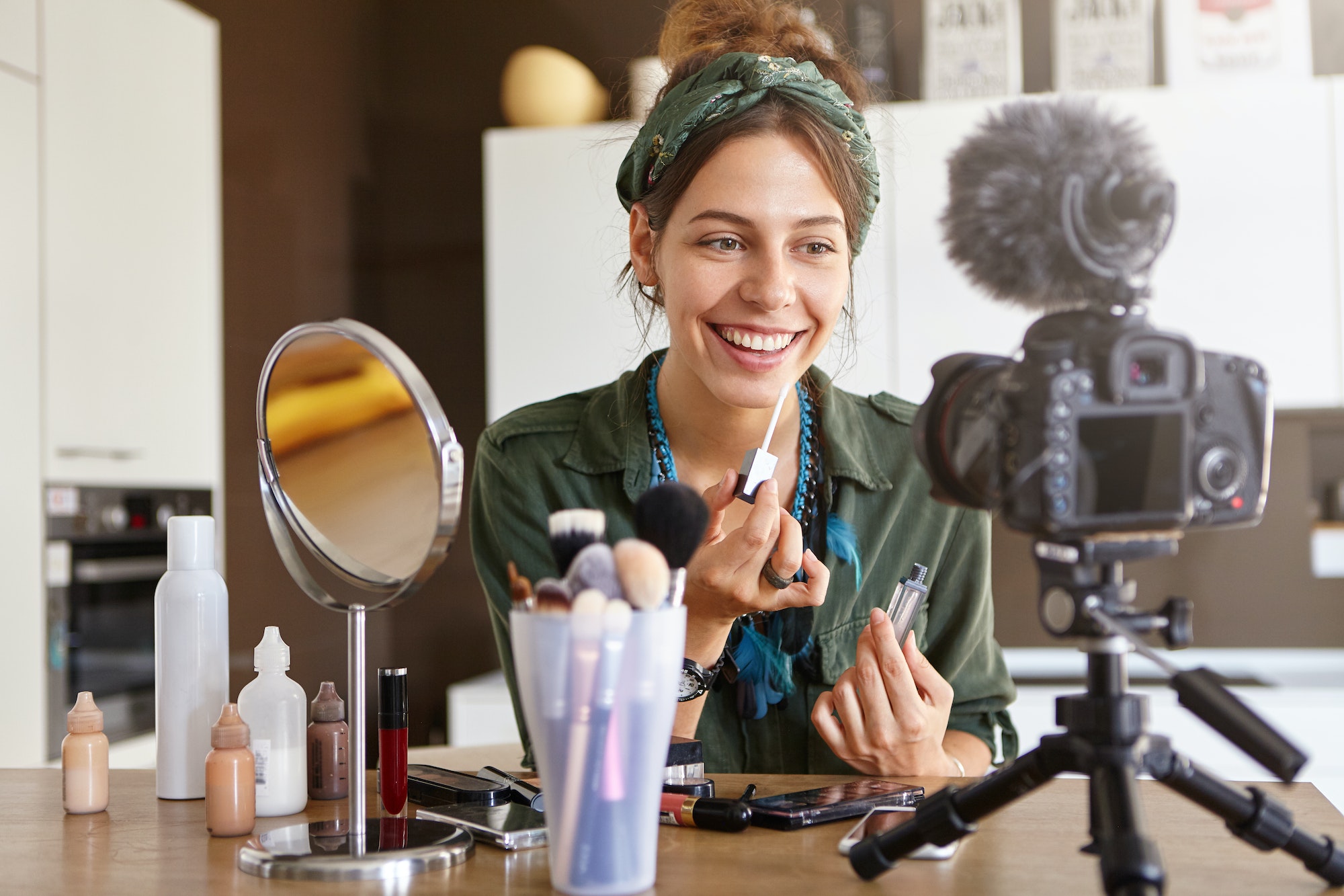 Beauty, fashion, technology, media and networking. Pretty girl vlogger sitting at dressing table sur